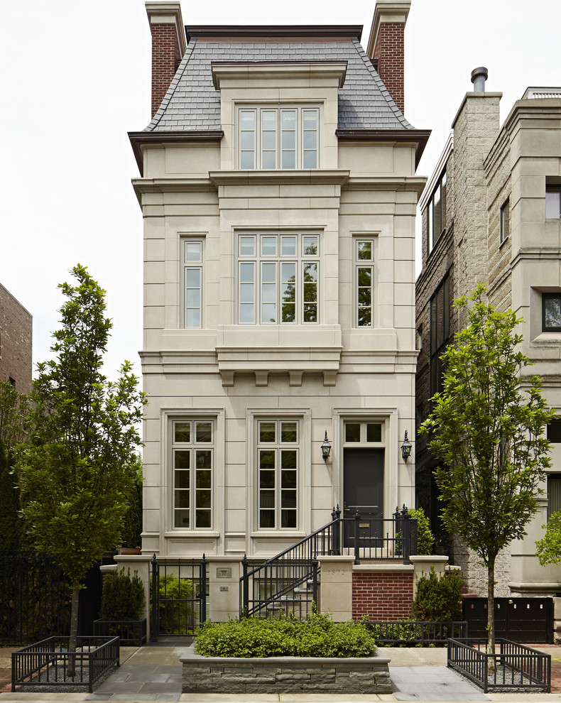 Inspiration for an expansive traditional three-storey beige townhouse exterior in Chicago.