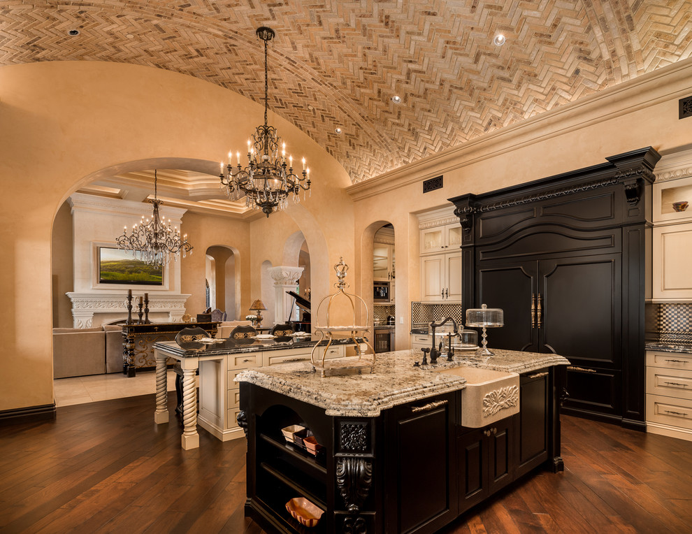 Inspiration for a huge rustic u-shaped dark wood floor and brown floor enclosed kitchen remodel in Phoenix with a farmhouse sink, recessed-panel cabinets, light wood cabinets, quartzite countertops, multicolored backsplash, mosaic tile backsplash, stainless steel appliances, two islands and multicolored countertops