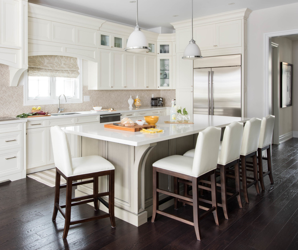 Example of a transitional l-shaped dark wood floor kitchen design in Toronto with an undermount sink, recessed-panel cabinets, white cabinets, beige backsplash, stainless steel appliances and an island