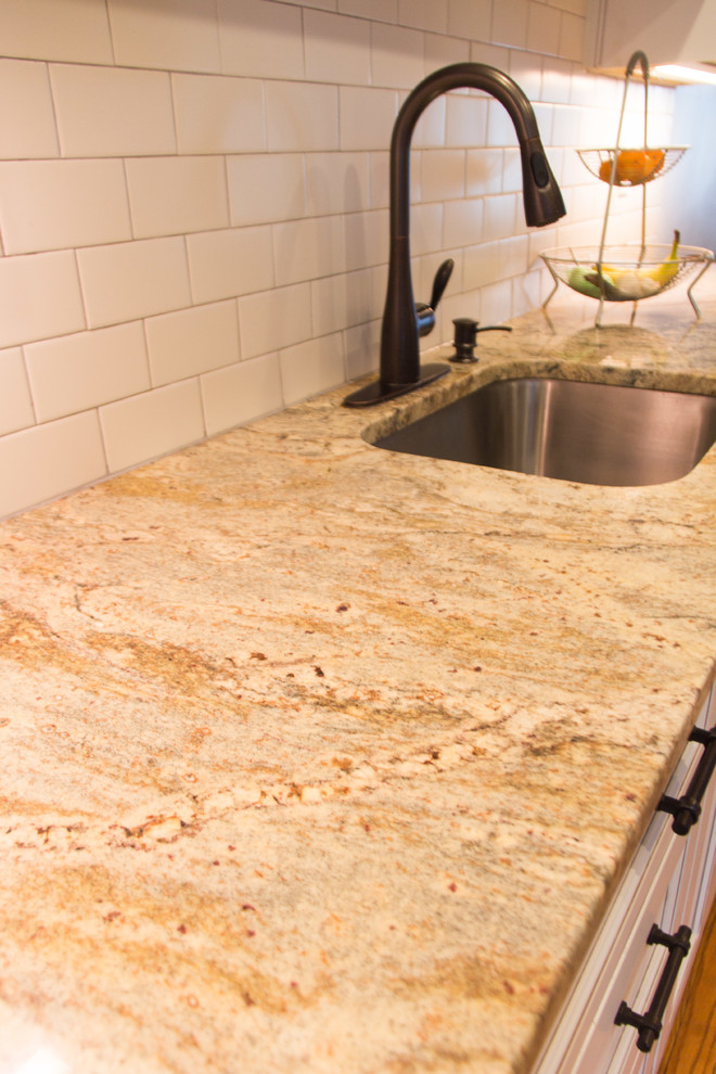 Kitchen - transitional medium tone wood floor kitchen idea with granite countertops, subway tile backsplash and stainless steel appliances