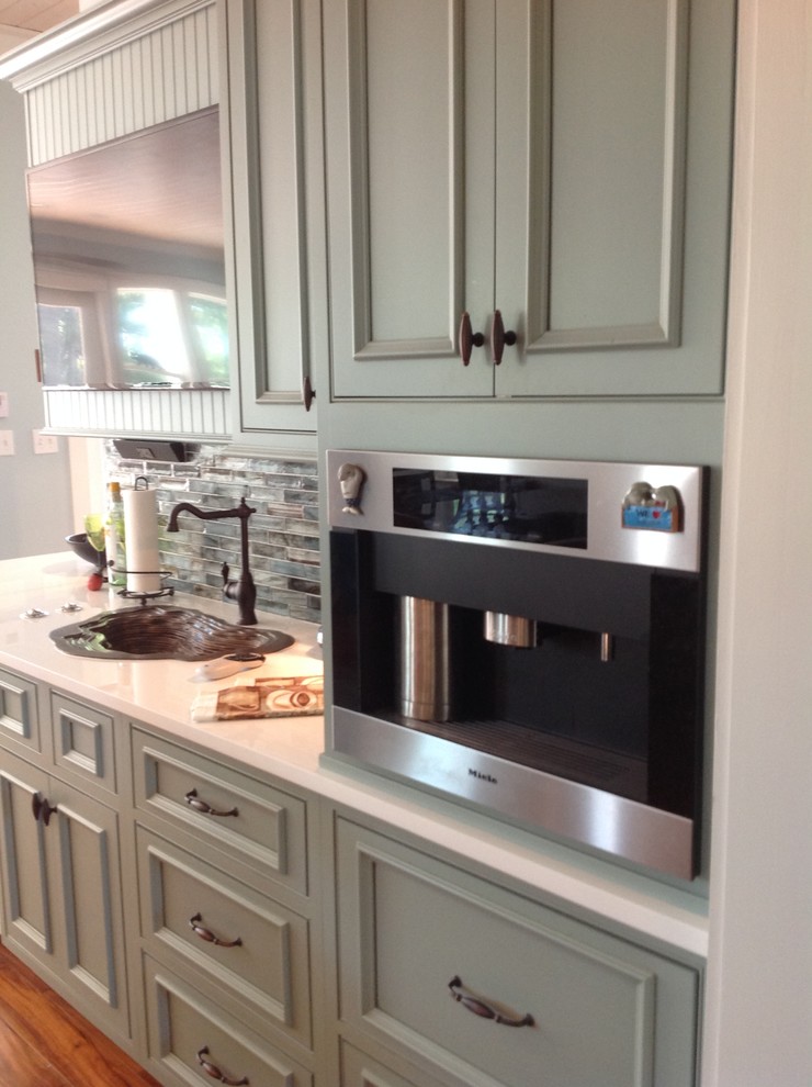 Inspiration for a large transitional u-shaped porcelain tile eat-in kitchen remodel in Miami with an undermount sink, flat-panel cabinets, green cabinets, quartz countertops, multicolored backsplash, mosaic tile backsplash, stainless steel appliances and an island
