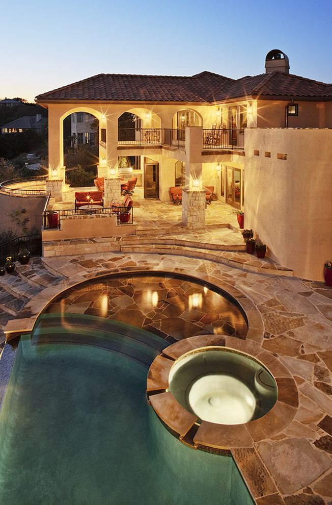 Large beige two-story stone exterior home photo in Austin
