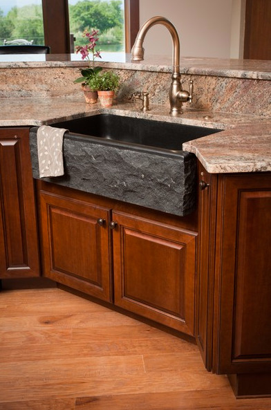 Inspiration for a large craftsman u-shaped medium tone wood floor and brown floor open concept kitchen remodel with a farmhouse sink, shaker cabinets, medium tone wood cabinets, granite countertops, multicolored backsplash, slate backsplash, stainless steel appliances and an island