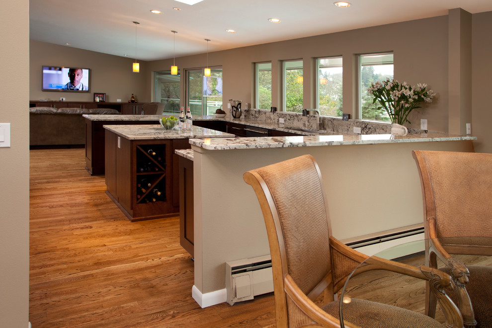 This is an example of a mid-sized contemporary u-shaped eat-in kitchen in Seattle with an undermount sink, shaker cabinets, dark wood cabinets, granite benchtops, multi-coloured splashback, stone slab splashback, stainless steel appliances and light hardwood floors.