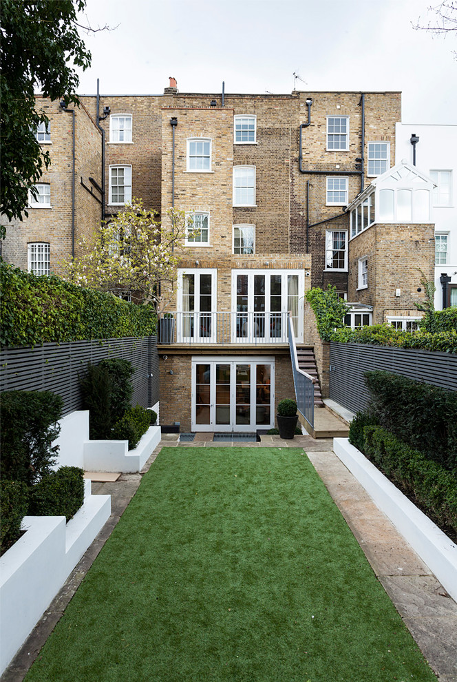 This is an example of a contemporary brick brown exterior in London with a flat roof.