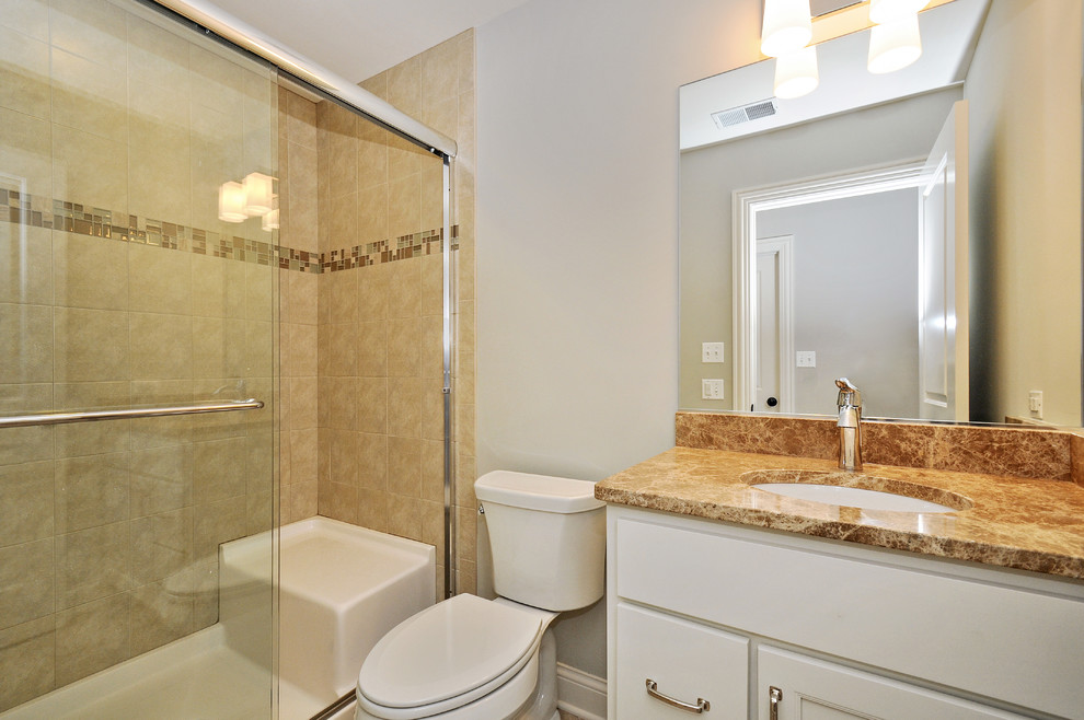 Design ideas for a mid-sized traditional 3/4 bathroom in Chicago with recessed-panel cabinets, white cabinets, an alcove shower, a two-piece toilet, white walls, an undermount sink and a sliding shower screen.