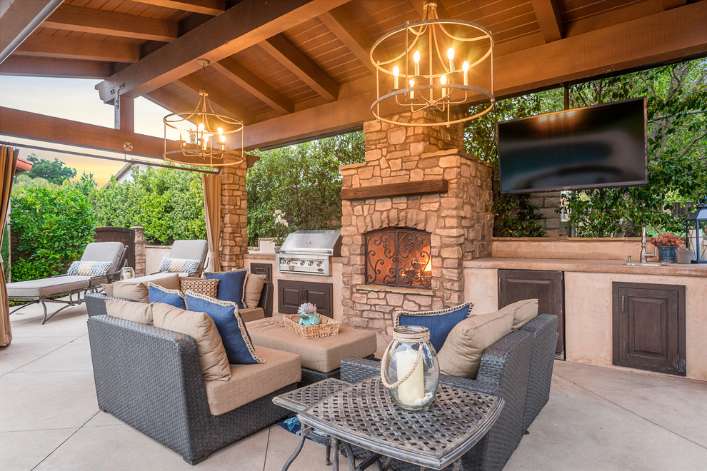 Photo of a mid-sized mediterranean backyard patio in Los Angeles with a fire feature and a gazebo/cabana.