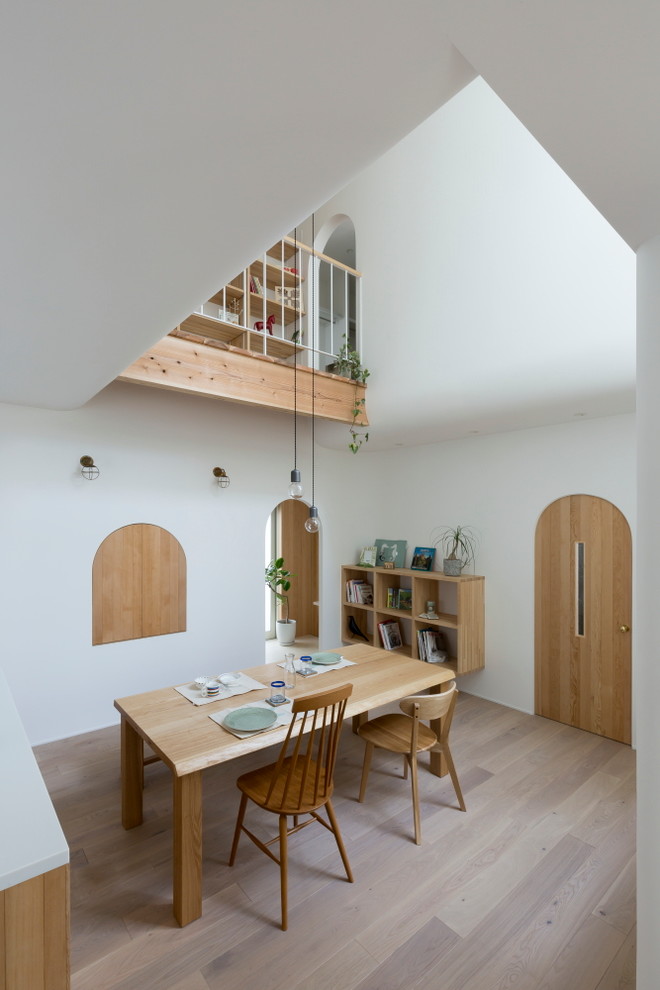 This is an example of a small asian open plan dining in Other with white walls, light hardwood floors and white floor.