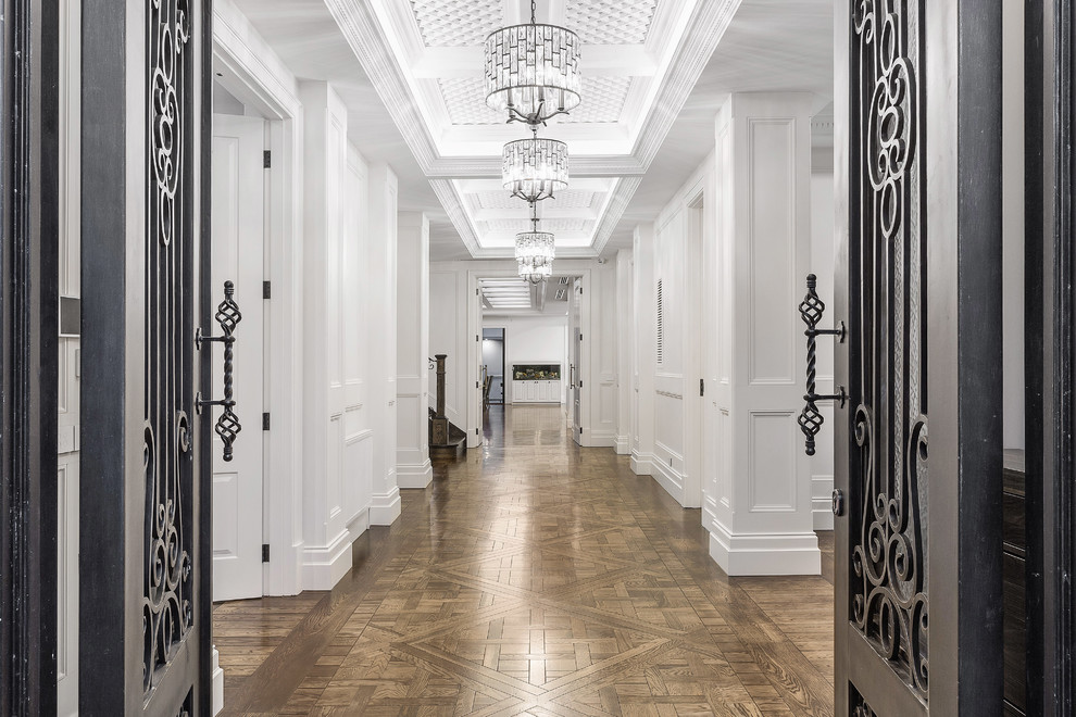 This is an example of an expansive traditional foyer in Melbourne with white walls, medium hardwood floors, a double front door, a metal front door and brown floor.