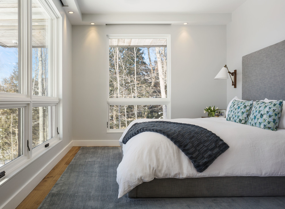 Mid-sized country bedroom in Burlington with white walls.