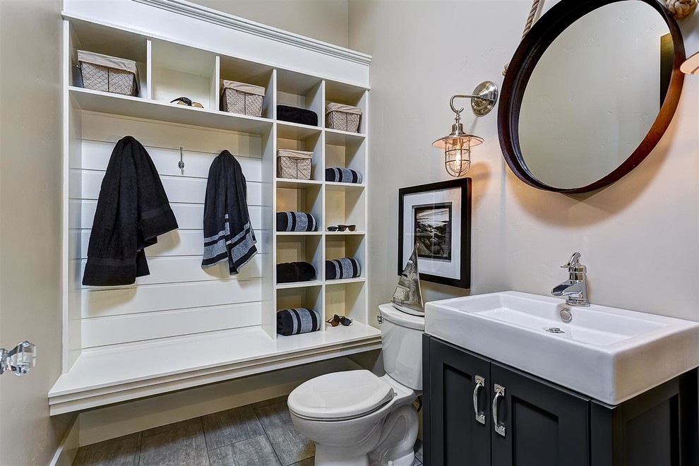 Inspiration for a mid-sized traditional 3/4 bathroom in Boise with shaker cabinets, black cabinets, grey walls, a two-piece toilet, gray tile, porcelain tile, porcelain floors and a trough sink.
