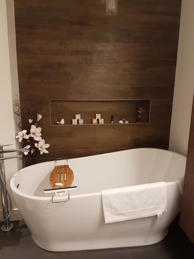 Example of a mid-sized transitional master brown tile and porcelain tile slate floor and gray floor freestanding bathtub design in Orange County with white walls, open cabinets and dark wood cabinets
