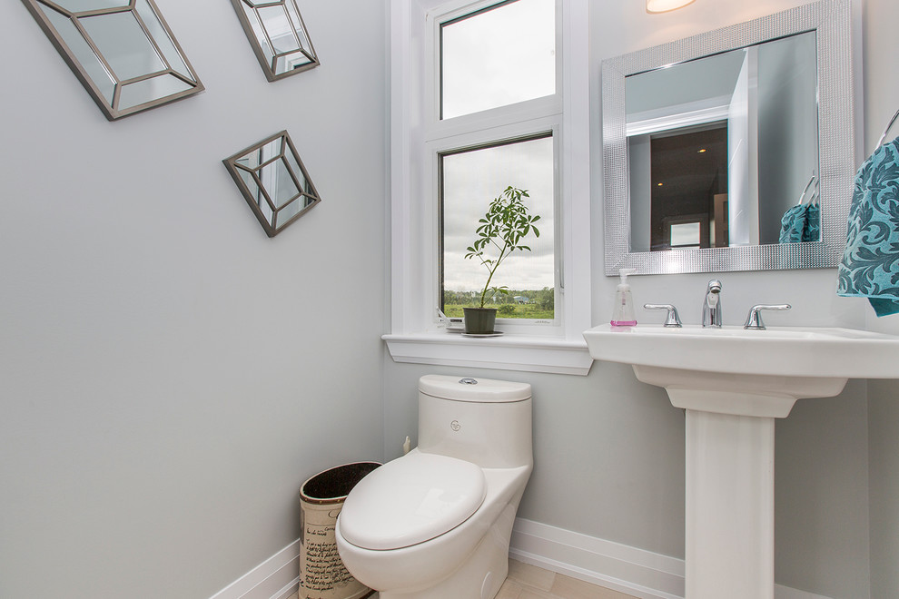 Photo of a mid-sized contemporary powder room in Ottawa with a one-piece toilet, blue walls, ceramic floors and a pedestal sink.
