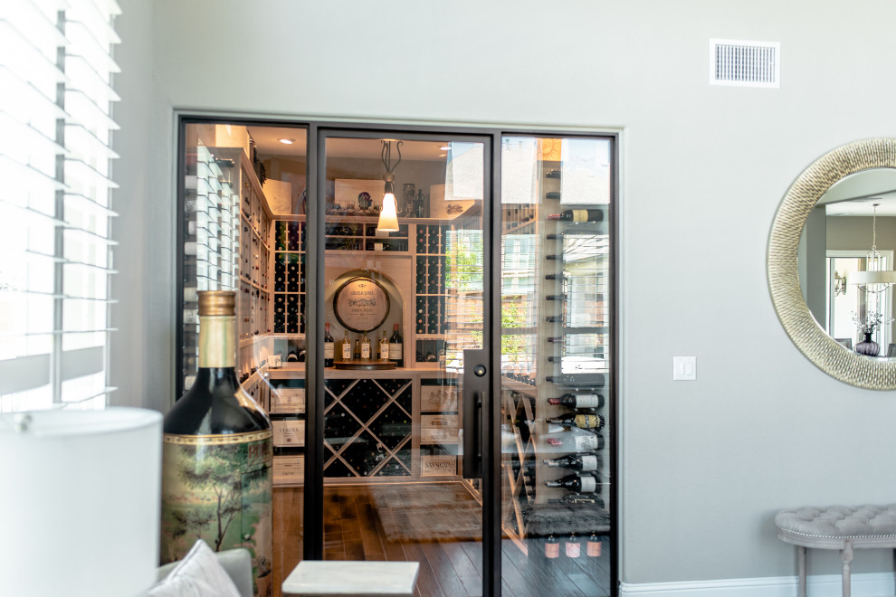 This is an example of a mid-sized contemporary wine cellar in Dallas with display racks and brown floor.