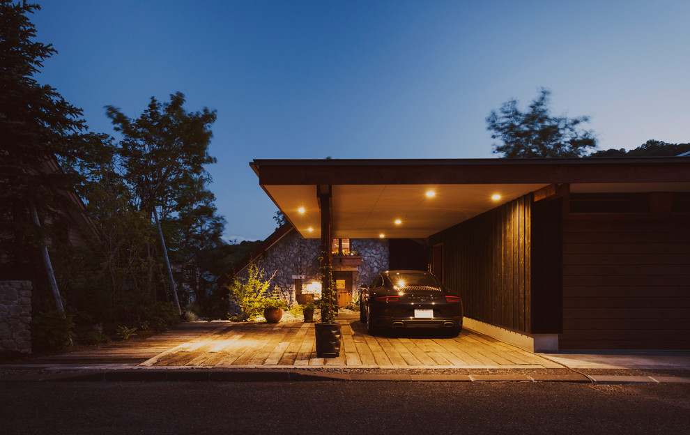 Photo of a mid-sized country attached garage in Sapporo.
