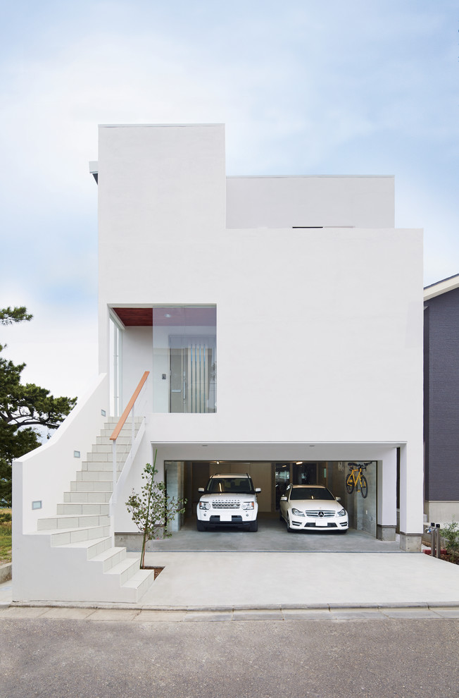 This is an example of a large modern three-storey stucco white house exterior in Other with a flat roof and a white roof.