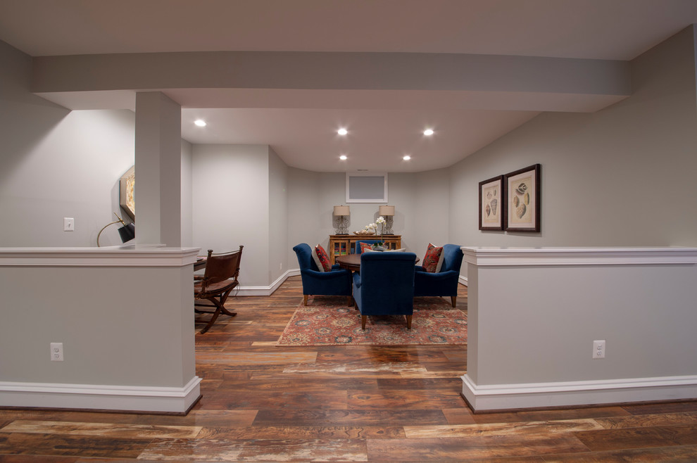 Design ideas for an expansive traditional walk-out basement in DC Metro with grey walls, medium hardwood floors, no fireplace and brown floor.
