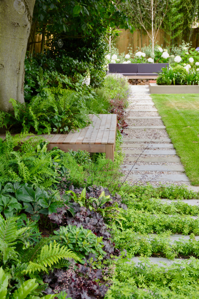 Photo of a large contemporary backyard formal garden in London.