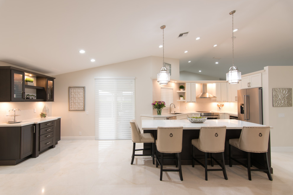 Example of a huge transitional l-shaped open concept kitchen design in Miami with an undermount sink, recessed-panel cabinets, white cabinets, quartz countertops, white backsplash, stainless steel appliances, an island and white countertops