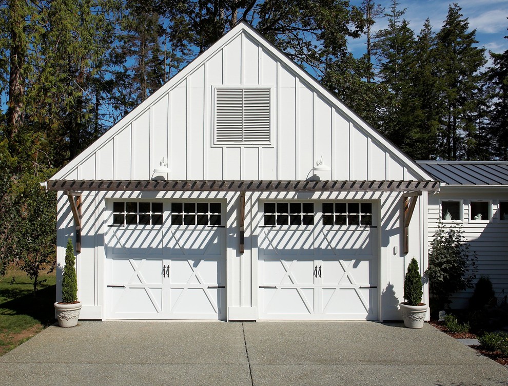 This is an example of a mid-sized eclectic attached two-car garage in Seattle.