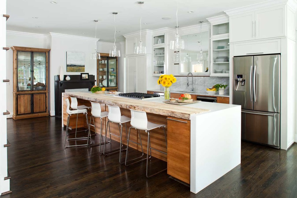 Inspiration for a contemporary galley open plan kitchen in Atlanta with an undermount sink, recessed-panel cabinets, white cabinets, solid surface benchtops, white splashback and stainless steel appliances.
