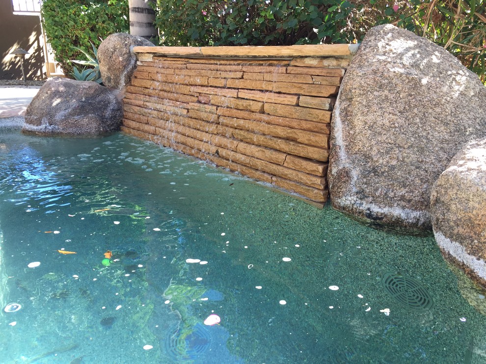 Inspiration for a small traditional backyard kidney-shaped pool in San Diego with natural stone pavers.