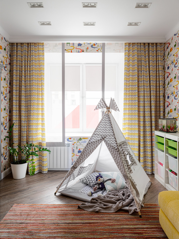 This is an example of a contemporary gender-neutral kids' playroom in Other with multi-coloured walls and brown floor.