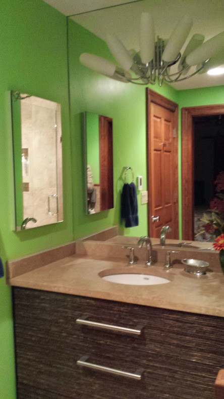 Example of a small eclectic 3/4 beige tile and stone tile travertine floor home design design with an undermount sink, brown cabinets, limestone countertops, a wall-mount toilet and green walls