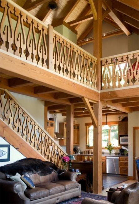 Example of a mid-sized mountain style straight wood railing staircase design