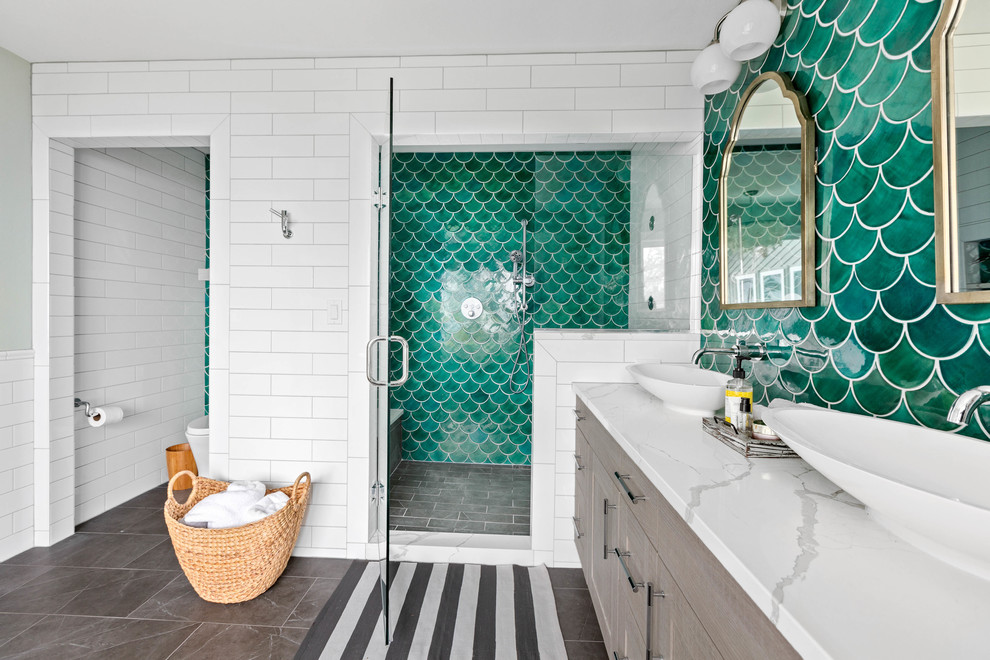 Design ideas for a large beach style master bathroom in Seattle with grey cabinets, a freestanding tub, an alcove shower, a one-piece toilet, green tile, mosaic tile, white walls, porcelain floors, a vessel sink, engineered quartz benchtops, grey floor, a hinged shower door and white benchtops.