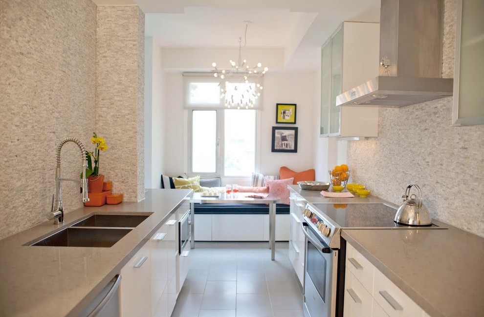 Contemporary galley separate kitchen in Toronto with stainless steel appliances, a double-bowl sink, quartz benchtops, flat-panel cabinets, white cabinets, grey splashback, stone tile splashback and porcelain floors.