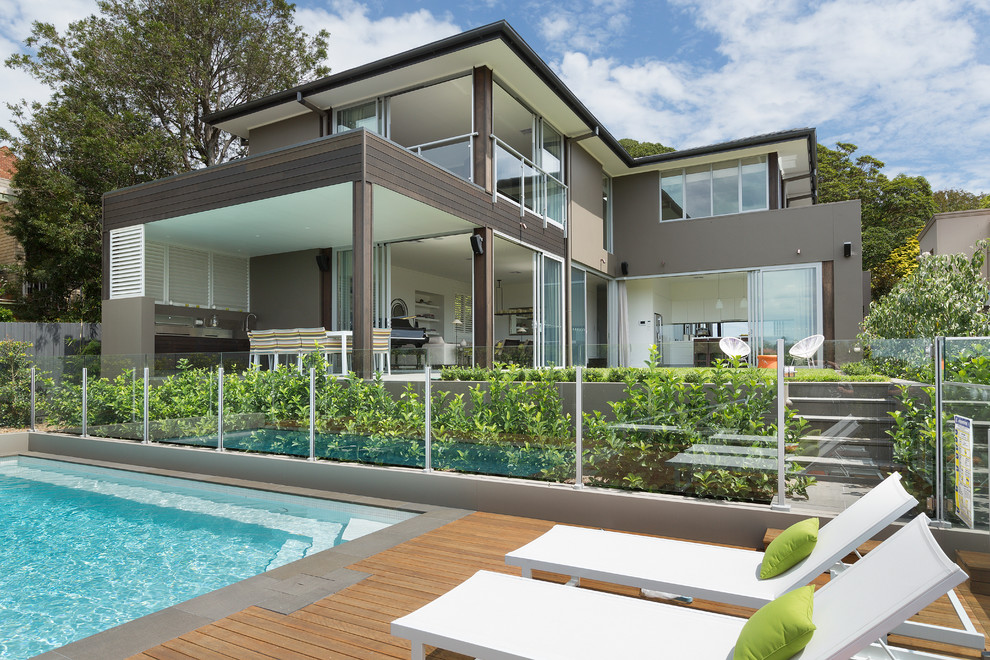 Mid-sized contemporary two-storey brown exterior in Sydney with mixed siding and a flat roof.