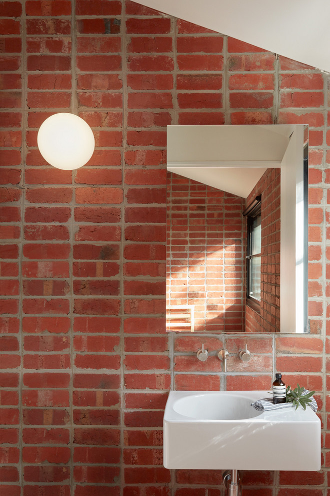 Scandinavian powder room in Melbourne with red walls, an integrated sink and white benchtops.