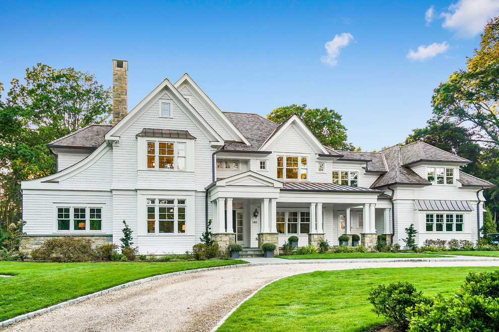Expansive traditional two-storey white exterior in New York with wood siding and a gable roof.