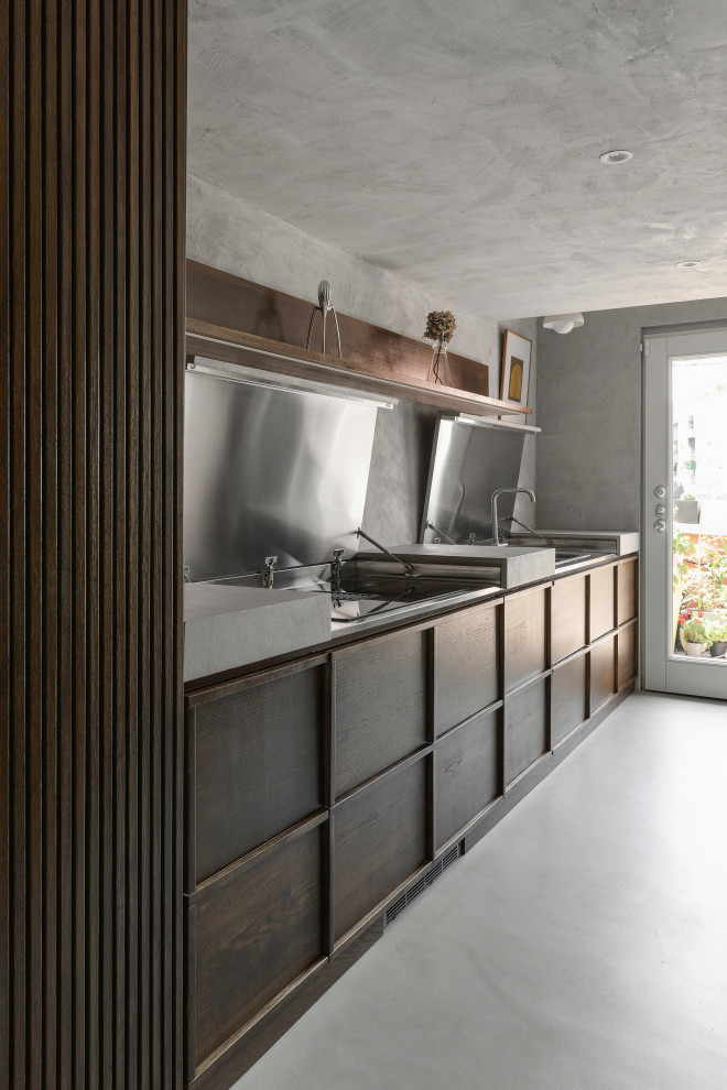Small scandi single-wall enclosed kitchen in Milan with dark wood cabinets, concrete worktops, grey splashback, concrete flooring, no island, grey floors and grey worktops.