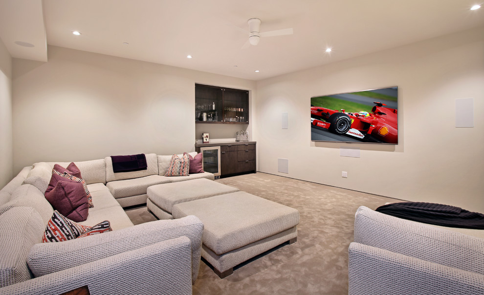 Mid-sized contemporary enclosed home theatre in Orange County with white walls, carpet and a wall-mounted tv.