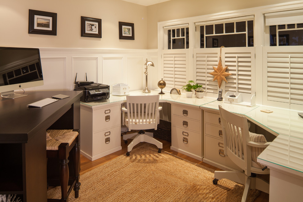 Inspiration for a traditional home office in Vancouver with beige walls, medium hardwood floors and a built-in desk.