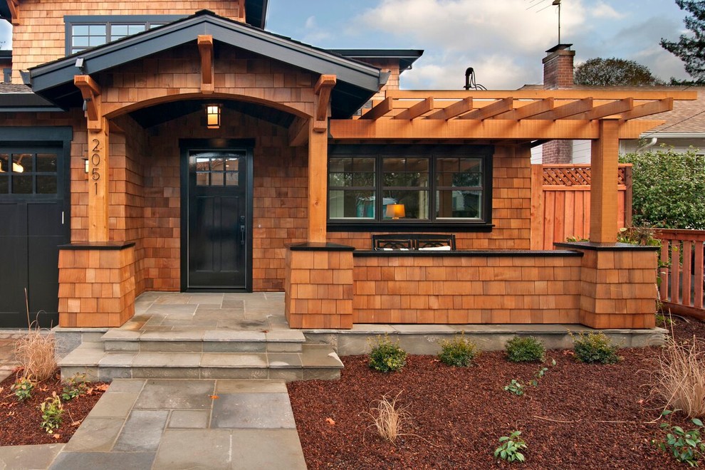 Inspiration for a modern front yard verandah in San Francisco with natural stone pavers and a pergola.