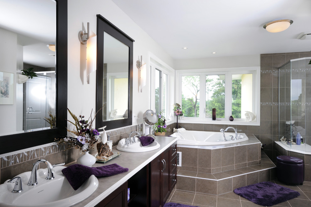 This is an example of a contemporary bathroom in Toronto with a corner tub.