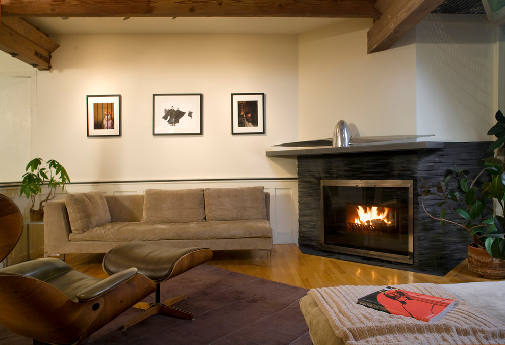 Photo of a contemporary living room in San Francisco with beige walls, medium hardwood floors and a corner fireplace.