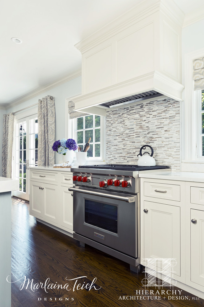 Inspiration for a large transitional u-shaped dark wood floor and brown floor open concept kitchen remodel in New York with a drop-in sink, recessed-panel cabinets, white cabinets, quartz countertops, multicolored backsplash, matchstick tile backsplash, stainless steel appliances and an island