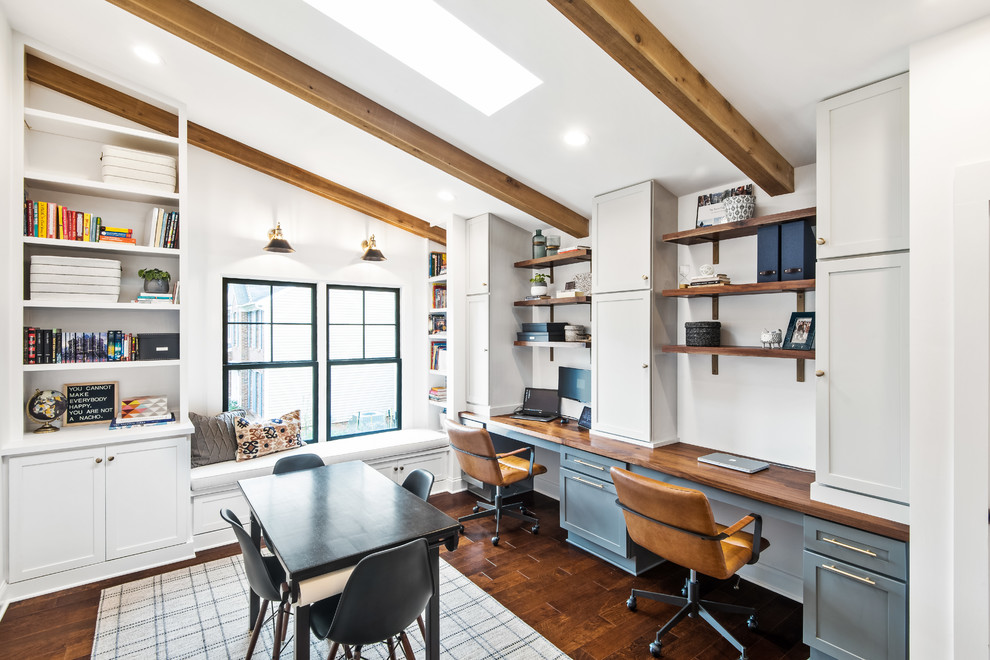 Inspiration for a farmhouse built-in desk dark wood floor and brown floor home office remodel in Raleigh with white walls