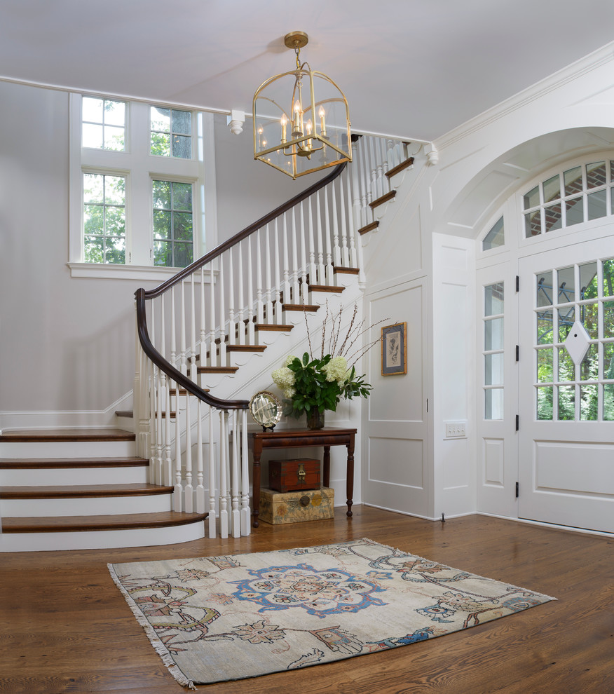 Design ideas for a mid-sized traditional entry hall in Philadelphia with beige walls, medium hardwood floors, a single front door and a white front door.