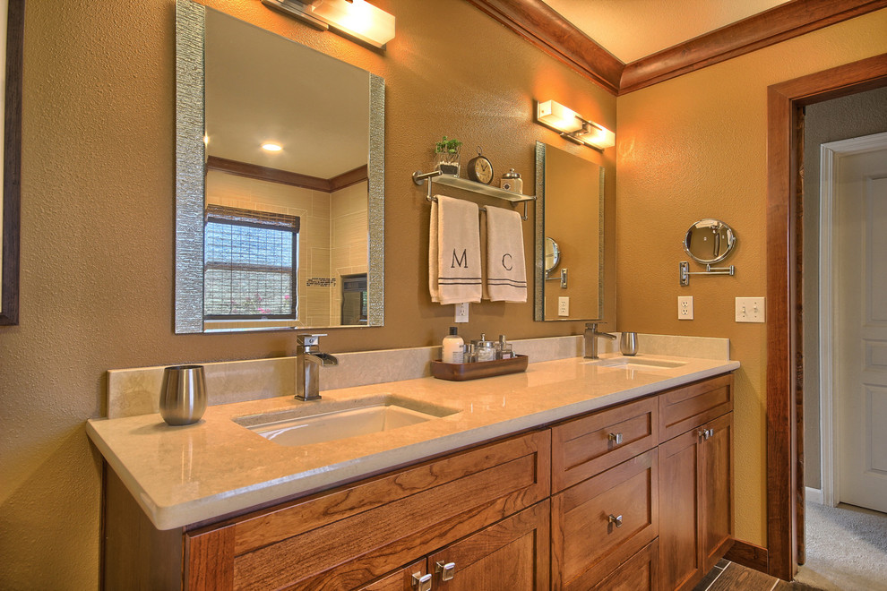 Mid-sized transitional master bathroom in Other with an undermount sink, shaker cabinets, medium wood cabinets, engineered quartz benchtops, a drop-in tub, a shower/bathtub combo, a two-piece toilet, beige tile, porcelain tile, yellow walls and porcelain floors.