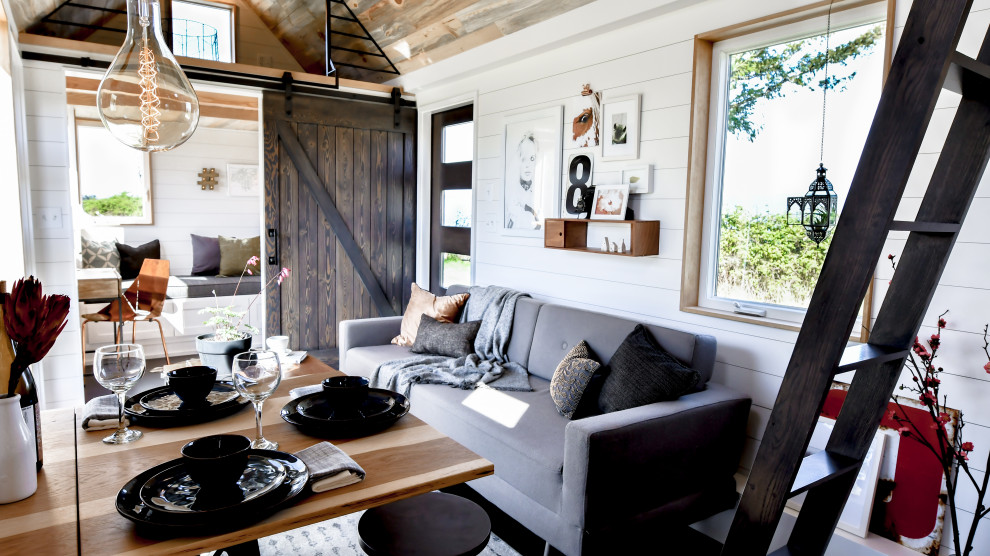 Inspiration for a small country loft-style living room in Other with white walls, cork floors, black floor, timber and planked wall panelling.