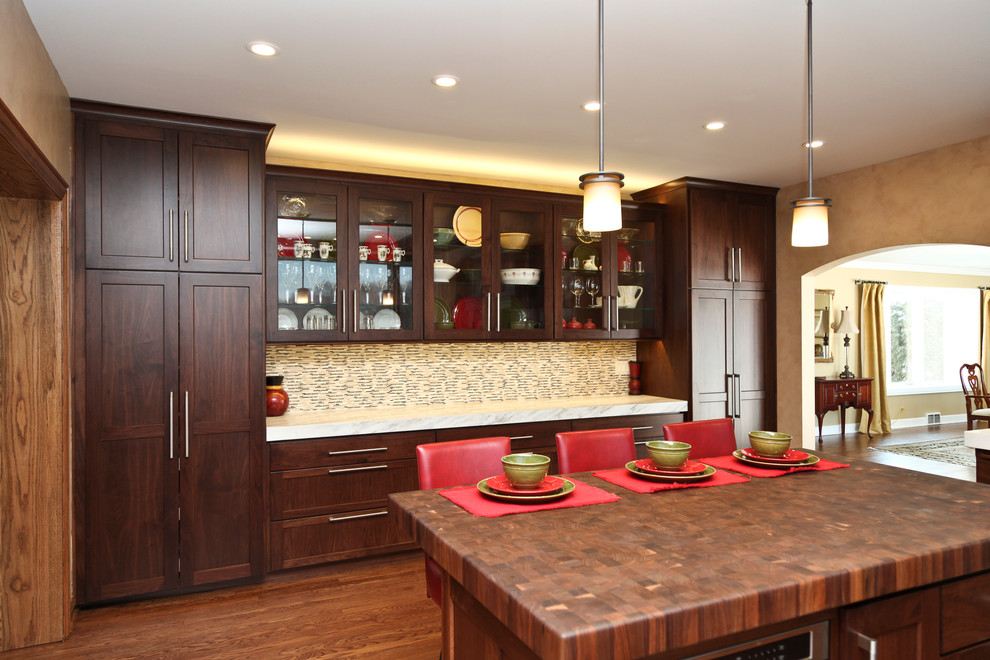 Inspiration for a transitional medium tone wood floor kitchen remodel in Chicago with an undermount sink, shaker cabinets, dark wood cabinets, wood countertops, multicolored backsplash, ceramic backsplash and stainless steel appliances