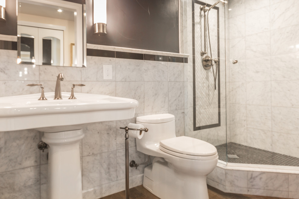 Photo of a small traditional master bathroom in Denver with a corner shower, a two-piece toilet, black and white tile, black walls, vinyl floors and a pedestal sink.
