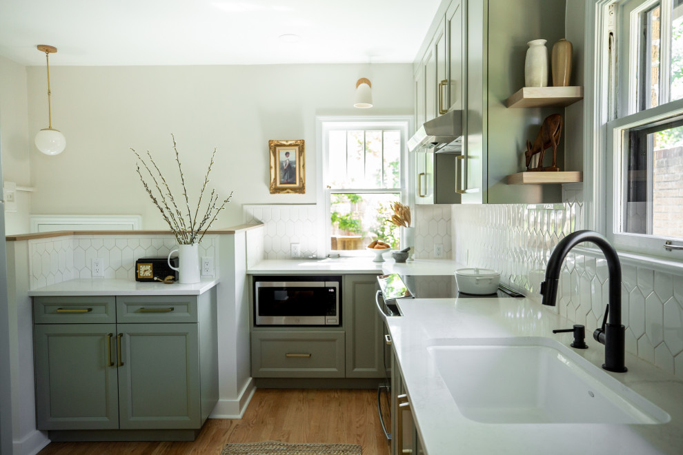 Inspiration for a small arts and crafts u-shaped separate kitchen in Denver with an undermount sink, recessed-panel cabinets, green cabinets, quartz benchtops, white splashback, ceramic splashback, stainless steel appliances, light hardwood floors, no island, brown floor and white benchtop.