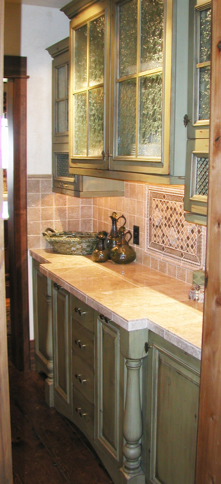 Mid-sized mountain style single-wall medium tone wood floor and brown floor eat-in kitchen photo with shaker cabinets, green cabinets, tile countertops, beige backsplash and ceramic backsplash