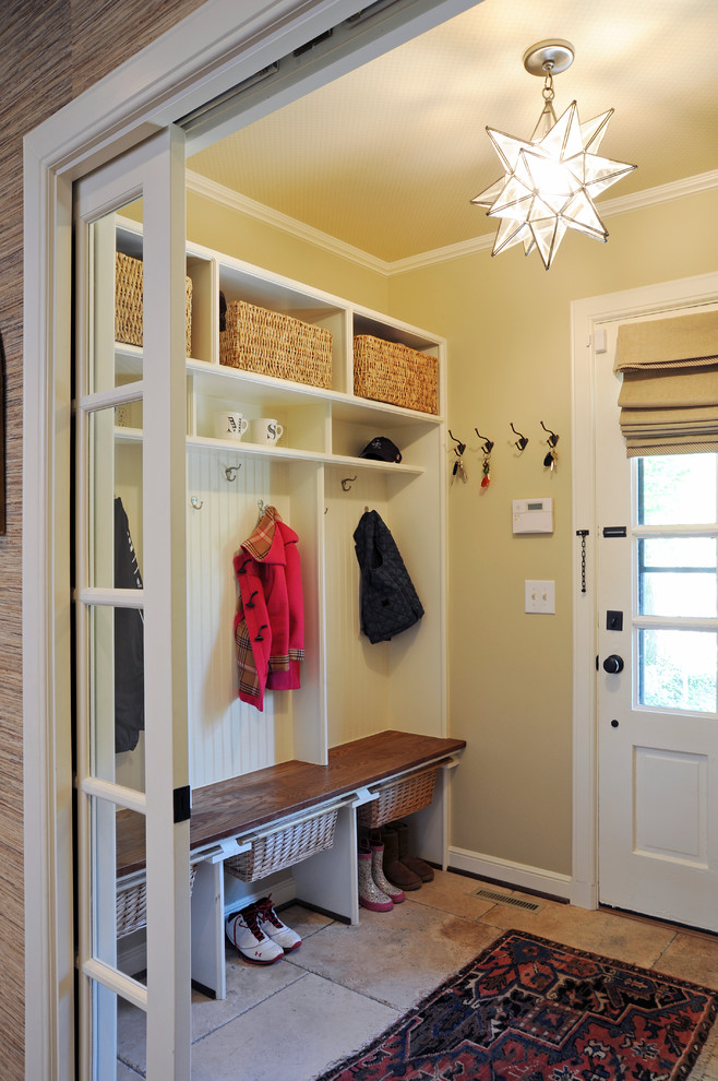 This is an example of a traditional mudroom in Columbus with beige walls, a single front door, a white front door and beige floor.